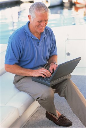 Mature Man Using Laptop Computer On Boat Stock Photo - Rights-Managed, Code: 700-00051205