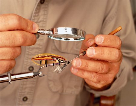 Male Flytier Tying Fishing Fly Under Magnifying Glass - Stock Photo -  Masterfile - Rights-Managed, Artist: Dan Lim, Code: 700-00051344