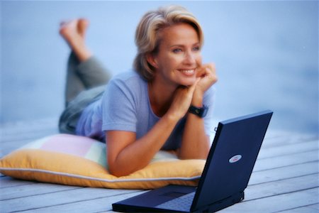 simsearch:700-00053035,k - Portrait of Mature Woman Lying on Dock with Laptop Computer Stock Photo - Rights-Managed, Code: 700-00052507