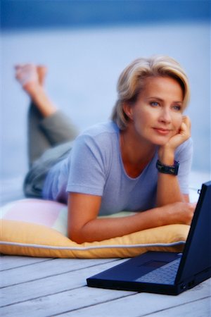 simsearch:700-00053497,k - Mature Woman Lying on Deck with Laptop Computer Stock Photo - Rights-Managed, Code: 700-00053035