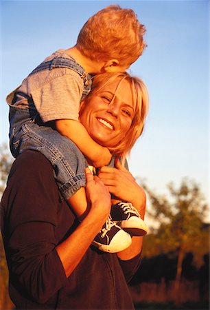 Mother Carrying Child on Shoulders Outdoors Fotografie stock - Rights-Managed, Codice: 700-00053133