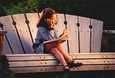 Girl Dressed as Businesswoman Sitting on Bench Using Cell Phone Stock Photo - Rights-Managed, Code: 700-00053275