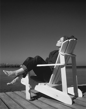 Woman Sitting in Adirondack Chair On Dock Stock Photo - Rights-Managed, Code: 700-00053498