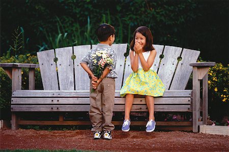 Boy Giving Bouquet of Flowers to Girl Sitting on Park Bench Stock Photo - Rights-Managed, Code: 700-00053670