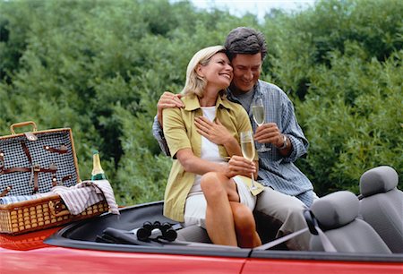 Mature Couple Sitting in Red Convertible, Drinking Champagne Stock Photo - Rights-Managed, Code: 700-00053788