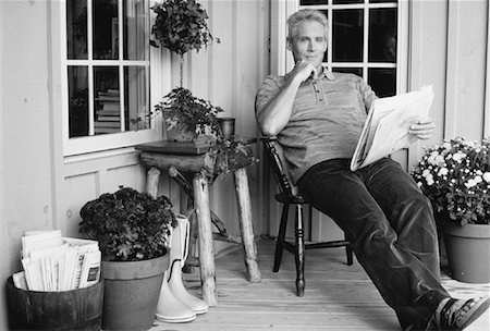 Portrait of Mature Man Sitting on Porch, Reading Newspaper Stock Photo - Rights-Managed, Code: 700-00053885