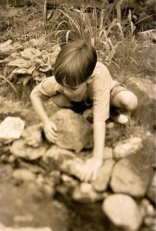 simsearch:700-00038046,k - Young Boy Moving Rocks in Garden Stock Photo - Rights-Managed, Code: 700-00053991