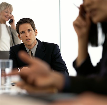 frustrated boardroom meeting - Business People Using Cell Phones in Meeting Stock Photo - Rights-Managed, Code: 700-00064072