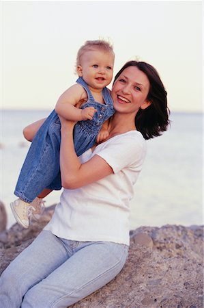 Portrait of Mother and Baby Sitting on Rock near Water Stock Photo - Rights-Managed, Code: 700-00064218