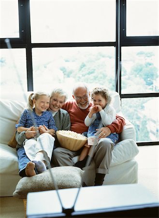 senior man watching tv family - Grandparents and Granddaughters Watching Television with Popcorn Stock Photo - Rights-Managed, Code: 700-00064987