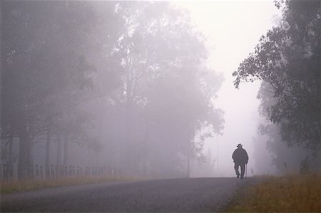 Back View of Man Walking on Road With Fog, NSW, Australia Stock Photo - Rights-Managed, Code: 700-00065057