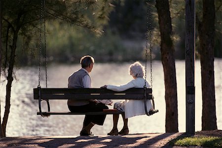 pictures of older adults sitting on porch swing - Back View of Mature Couple on Swing in Park, Miami, FL, USA Stock Photo - Rights-Managed, Code: 700-00065296