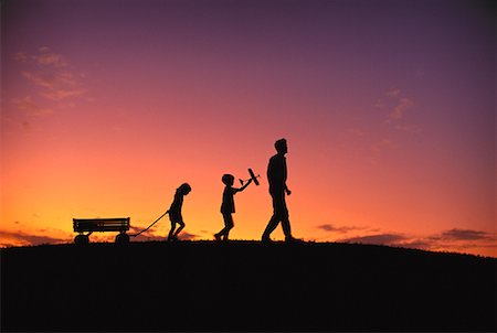 silhouette father and son sunset - Silhouette of Family Walking Across Field at Dusk Stock Photo - Rights-Managed, Code: 700-00065293