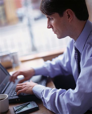 picture of man sitting alone diner - Businessman Using Laptop Computer in Cafe Stock Photo - Rights-Managed, Code: 700-00065318