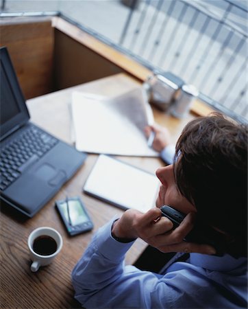 simsearch:700-00592868,k - Overhead View Of Businessman In Restaurant Using Cell Phone Foto de stock - Con derechos protegidos, Código: 700-00065320