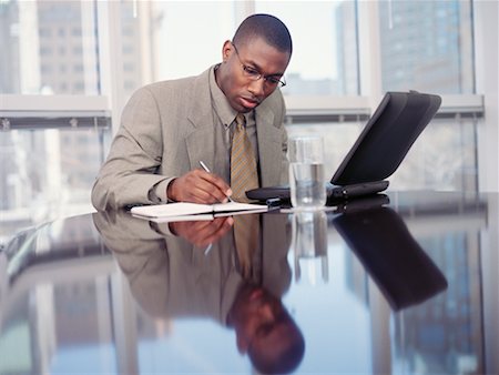 simsearch:700-00367646,k - Businessman Sitting at Table Writing in Notepad Stock Photo - Rights-Managed, Code: 700-00065396