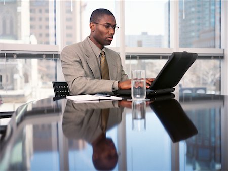 simsearch:700-00367646,k - Businessman Sitting at Table Using Laptop Computer Stock Photo - Rights-Managed, Code: 700-00065397