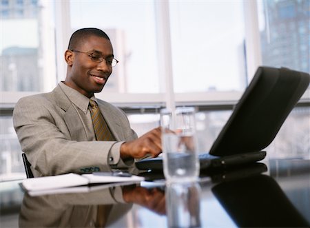 simsearch:700-00367646,k - Businessman Sitting at Table Using Laptop Computer Stock Photo - Rights-Managed, Code: 700-00065399