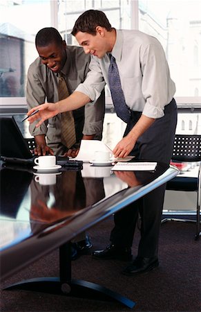 Two Businessmen Standing at Table Using Laptop Computer Stock Photo - Rights-Managed, Code: 700-00065414