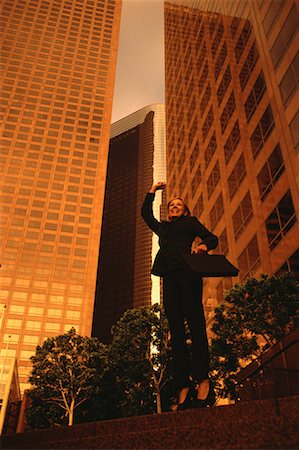simsearch:700-00039942,k - Ecstatic Businesswoman Jumping in Air Near Office Towers Stock Photo - Rights-Managed, Code: 700-00065556