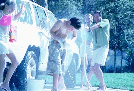 family car wash - Family Washing Car, Having Water Fight Stock Photo - Rights-Managed, Code: 700-00065614