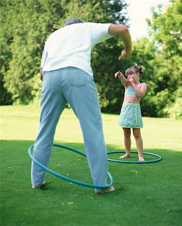 Grandfather and Granddaughter Playing with Hula Hoops Outdoors Stock Photo - Rights-Managed, Code: 700-00065799