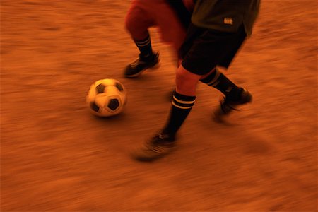 Close-Up of Soccer Players Kicking Ball Stock Photo - Rights-Managed, Code: 700-00066411