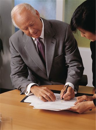 Mature Businessman Signing Document Stock Photo - Rights-Managed, Code: 700-00066620