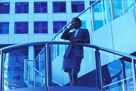 simsearch:700-00071171,k - Businesswoman Using Cell Phone Leaning on Railing Outdoors Stock Photo - Rights-Managed, Code: 700-00066650