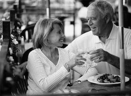 Mature Couple Toasting with Glasses at Outdoor Cafe Stock Photo - Rights-Managed, Code: 700-00066756