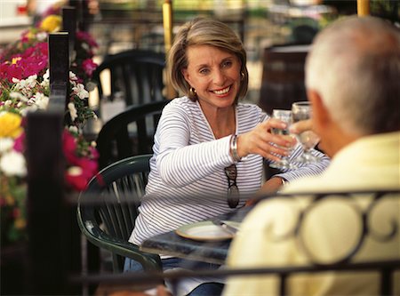 Mature Couple Toasting with Glasses at Outdoor Cafe Stock Photo - Rights-Managed, Code: 700-00066758