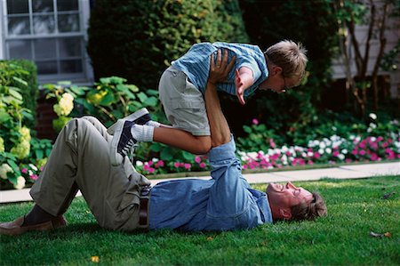father child yard not illustration not business not vintage not 20s not 30s not 40s not 70s not 80s - Father and Son Playing Outdoors Stock Photo - Rights-Managed, Code: 700-00067026