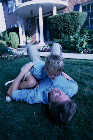 father play garden house - Father and Son Playing Outdoors Stock Photo - Rights-Managed, Code: 700-00067022