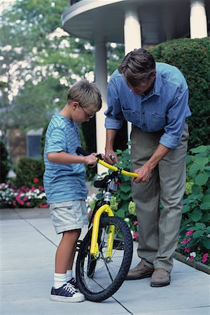 simsearch:700-00038126,k - Father and Son Fixing Bicycle Outdoors Foto de stock - Con derechos protegidos, Código: 700-00067031