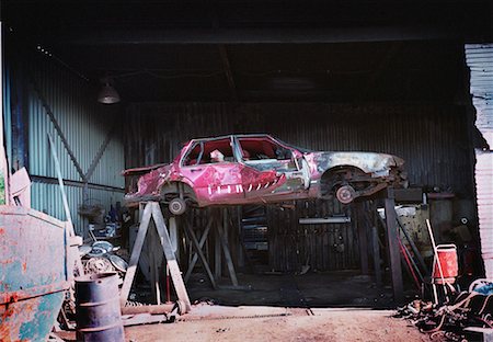 Damaged Car on Risers in Garage Stock Photo - Rights-Managed, Code: 700-00067066