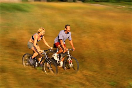 simsearch:700-03439938,k - Couple Biking through Field of Tall Grass, Maine, USA Stock Photo - Rights-Managed, Code: 700-00067083