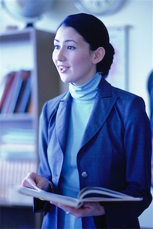 Female Teacher Reading from Textbook in Classroom Stock Photo - Rights-Managed, Code: 700-00067270