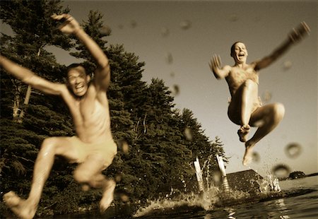 Couple in Swimwear, Jumping into Water from Dock Belgrade Lakes, Maine, USA Stock Photo - Rights-Managed, Code: 700-00067443