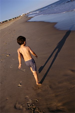 rhode island - Back View of Boy in Swimwear Walking on Beach Rhode Island, USA Stock Photo - Rights-Managed, Code: 700-00067824