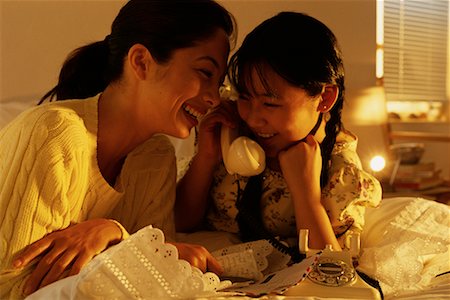 Mother and Daughter on Bed, Using Phone Stock Photo - Rights-Managed, Code: 700-00067895