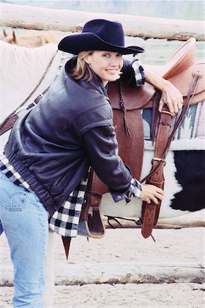 simsearch:700-00067839,k - Portrait of Woman Adjusting Saddle Foto de stock - Direito Controlado, Número: 700-00067949
