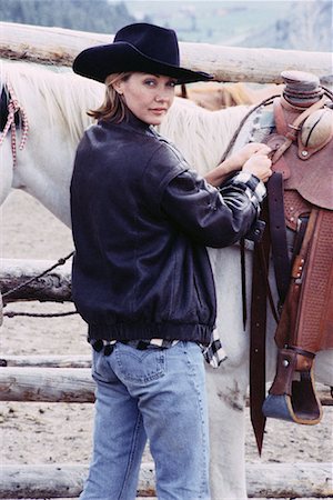 ranchers - Portrait of Woman Adjusting Saddle Stock Photo - Rights-Managed, Code: 700-00067950