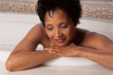 Woman Leaning on Edge of Bathtub Resting Head on Hands Stock Photo - Rights-Managed, Code: 700-00068045