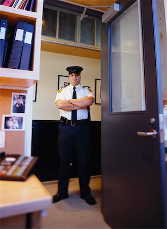 fat men in uniform - Portrait of Male Security Guard Standing in Doorway with Arms Crossed Stock Photo - Rights-Managed, Code: 700-00068598