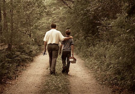father son caucasian walking two people casual clothing - Back View of Father and Son on Dirt Road with Fishing Gear Stock Photo - Rights-Managed, Code: 700-00068631