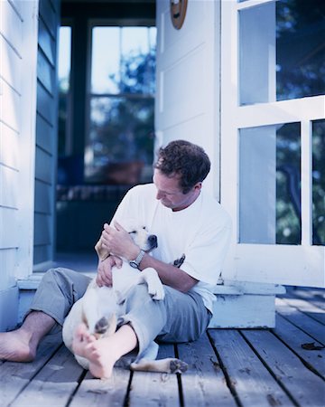 Man Sitting on Deck with Dog Bala, Ontario, Canada Stock Photo - Rights-Managed, Code: 700-00068787