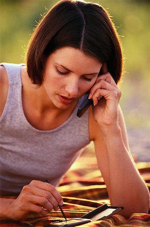 simsearch:700-00782647,k - Woman Lying on Blanket Using Cell Phone and Electronic Organizer Outdoors, Toronto, ON, Canada Stock Photo - Rights-Managed, Code: 700-00069755