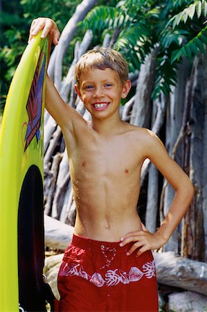 elementary age boy belly - Portrait of Boy in Swimwear Leaning on Surfboard Stock Photo - Rights-Managed, Code: 700-00069885