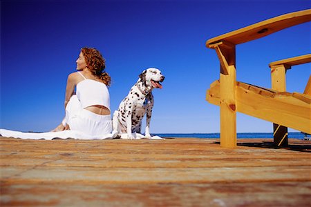 Back View of Woman Sitting on Dock with Dalmatian Stock Photo - Rights-Managed, Code: 700-00069894