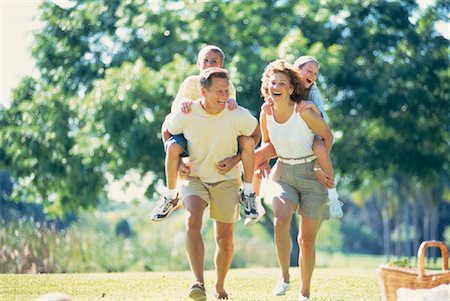 family picnics play - Mother and Father Carrying Son And Daughter on Backs Outdoors Stock Photo - Rights-Managed, Code: 700-00060128